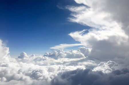 White cloud on blue sky. See through the plane window