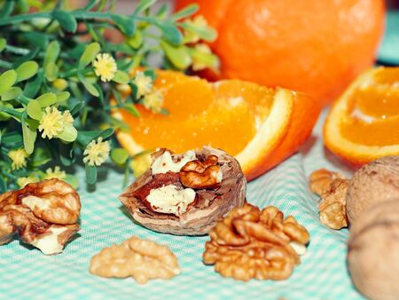 Healthy snack with walnuts and orangesの写真素材