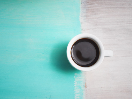 Cup of espresso coffee on white plate and wooden tableの写真素材
