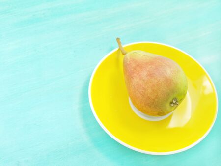 Pears on green pastel wooden background with copy space, retro moodの写真素材
