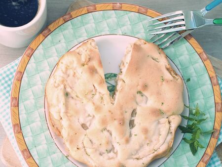 Charlotte apple pie garnished with lime zest and mint leaves, toned