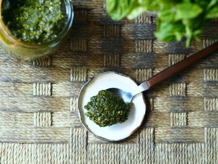 Still life with Italian sauce pesto on rustic background, selective focusの写真素材