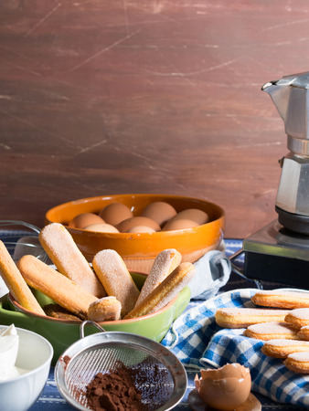 Cooking tiramisu dessert with eggs, mascarpone, savoiardi buscuits and espresso coffeeの写真素材