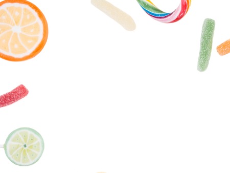 Fruit lollipops and candies isolated on white, copy spaceの写真素材