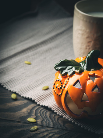 Decorative squash on gray napkin on dark wooden background. Vertical toned image with vignette.の写真素材