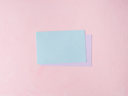 Green Pastel color card on pink textured background. Baby birthday party invitation or valentine. Copy spaceの写真素材