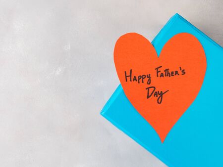 Blue box present with paper red heart hand written Happy Fathers day