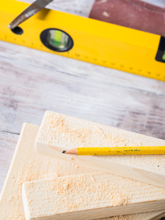 Wooden board with tools for manual measuring cutting - meter, level, pencil. Bricolage hand made DIY...