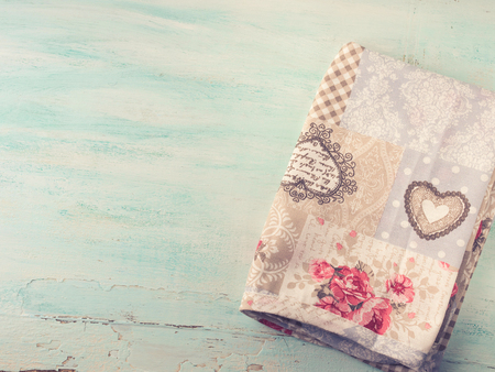 Vintage apron cloth napkin on green spring pastel color wooden background. top view. Copy spaceの写真素材