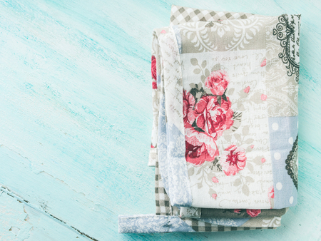 Vintage apron cloth napkin on green spring pastel color wooden background. top view. Copy spaceの写真素材