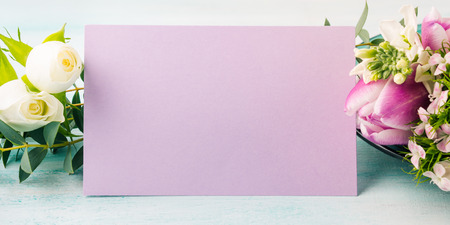 Empty purple card flowers tulips roses spring pastel color background. Easter holiday, wedding birthday invitationの写真素材