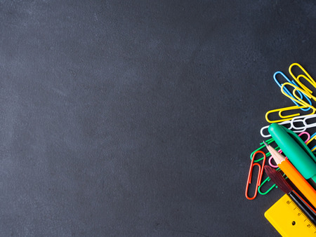 Colorful stationery back to school concept on blackboard backgroundの写真素材