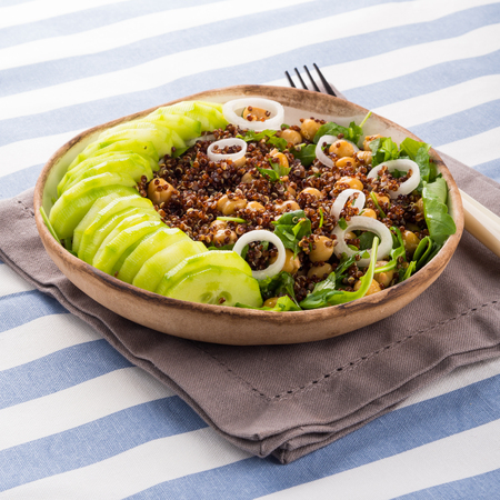 Quinoa salad bowl with cucumbers, chickpeas, onions, arugula. Light protein healthy dinner lunchの写真素材
