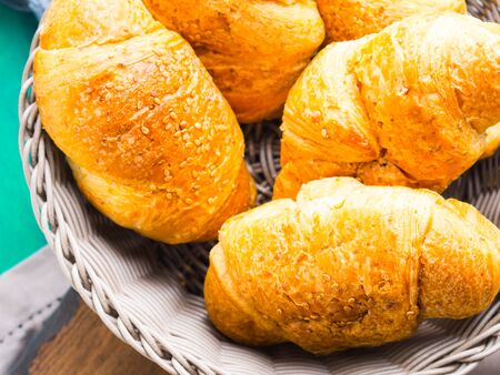 Savory croissants with sesame seeds in basketの写真素材