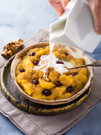 Amaranth porridge with apple, cinnamon, turmeric and dried fruit. Gluten free breakfast mealの写真素材
