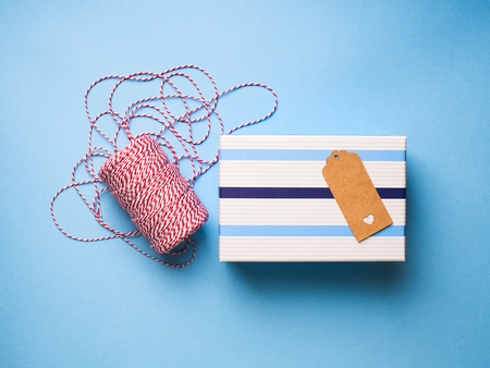 Wrapping christmas gifts concept with gift boxes, twine and tagsの写真素材