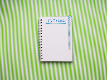 White notebook on green. To do list to be writtenの写真素材