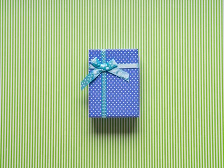 Blue gift box on green background. Holiday father's day conceptの写真素材