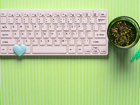 Green smoothie and white keyboard. Healthy lifestyle blogging or promotion conceptの写真素材