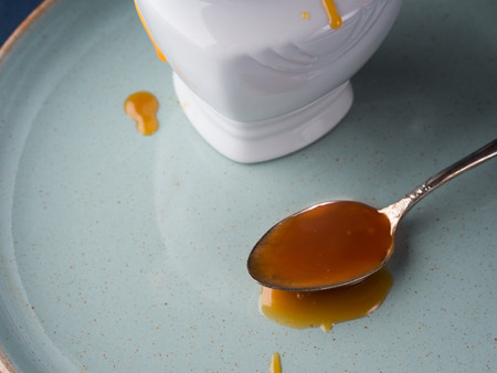 Salted caramel in a spoon on dark backgroundの写真素材