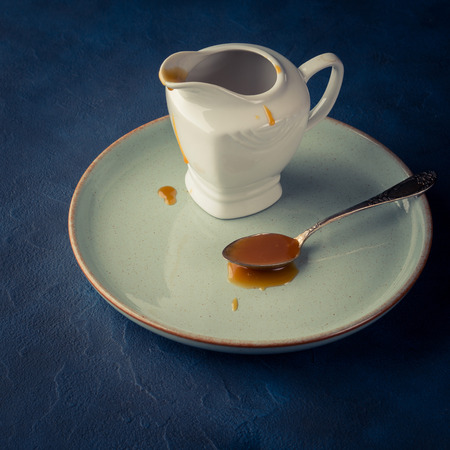 Salted caramel in a spoon on dark backgroundの写真素材