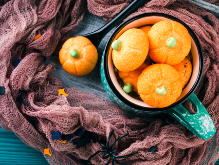 Hot cocoa with pumpkin marshmallows on dark styled Halloween backgroundの写真素材