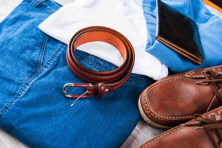 Mans clothes and leather accessories on wooden backgroundの写真素材