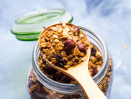 Homemade granola with honey and chestnuts in a glass jarの写真素材