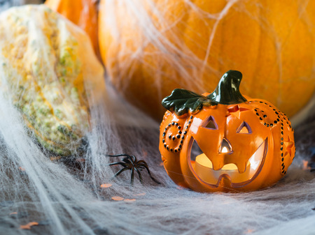 Halloween squash and candle. Spider net. Holiday spooky background still lifeの写真素材