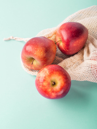 Red apples in reusable cotton bags. Zero waste, fruit grocery shoppingの写真素材