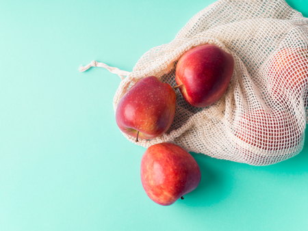 Red apples in reusable cotton bags. Zero waste, fruit grocery shoppingの写真素材