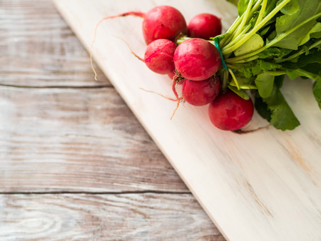 Fresh radish on wooden board for salad. Organic food grocery shoppingの写真素材