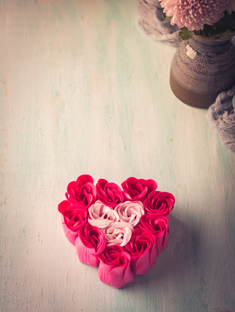 Heart shaped pink red roses on pastel color background. Wedding baby shower symbol invitation. Valentine mother day greeting cardの写真素材