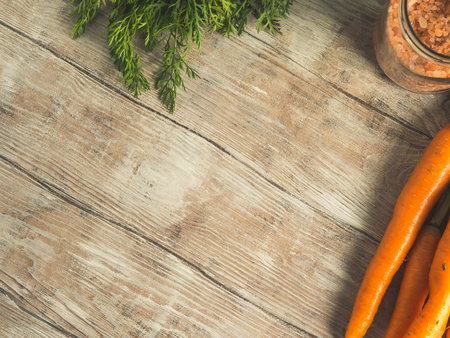 Raw carrots on rustic wooden background. Cooking vegetablesの写真素材