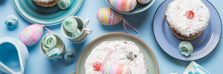Easter concept background with cake and decor eggs on minimal blue