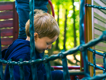 Little 5-year old boy playing on a playground. Active happy childの写真素材