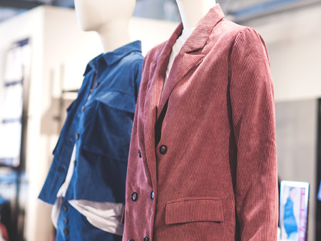 White mannequin wearing color casual jackets in a fast fashion store