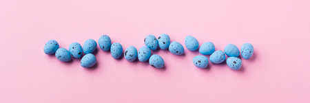 Blue decor easter eggs on pastel pink background. Flat layの写真素材