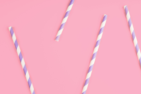 Purple paper straws on pink color background. Patternの写真素材