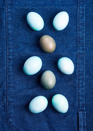 Easter boiled eggs as bunny symbol on blue jeans apron background. Holiday flat layの写真素材