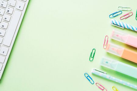 Pastel mint green back to school flat lay with blank white page, stationery, keyboard, succulent, sneakers. Workspace. Blogging conceptの写真素材