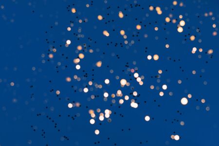 Festive classic blue 2020 color background with golden star falling confetti and magic lights....