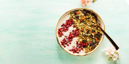 Home made smoothie bowl with yogurt and pomegranate with granola of dried fruit, seeds and nuts....