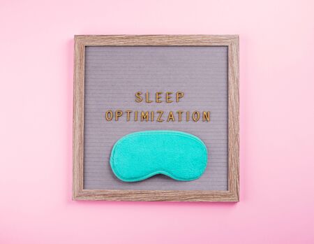 Sleep optimization text composed on wooden letter board with green sleeping mask. Better healthy sleep tips conceptの写真素材