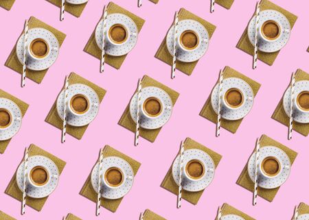 Cup of espresso coffee flat lay pattern with golden notebook diary on pink color background. Pop art...