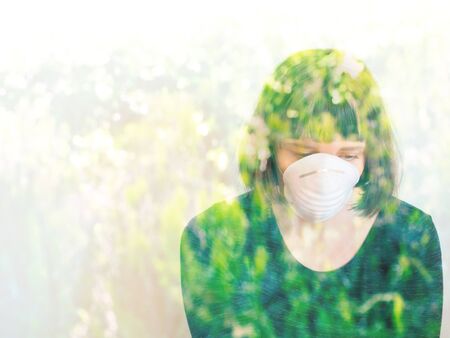 Young woman with face mask during Coronavirus pandemic staying home but missing nature and walks...