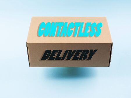 Contactless delivery concept. Cardboard box in levitation with textの写真素材