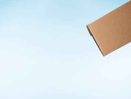 Contactless delivery concept. Cardboard box in levitation, copy space