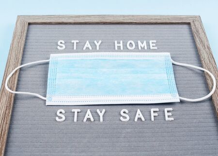 Stay home, stay safe message text on letter board with face mask during covid19 pandemic. Protect...