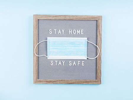 Stay home, stay safe message text on letter board with face mask during covid19 pandemic. Protect...